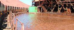 The floating container is unique in its ability to float on a pontoon that follows the movement of the mining pond